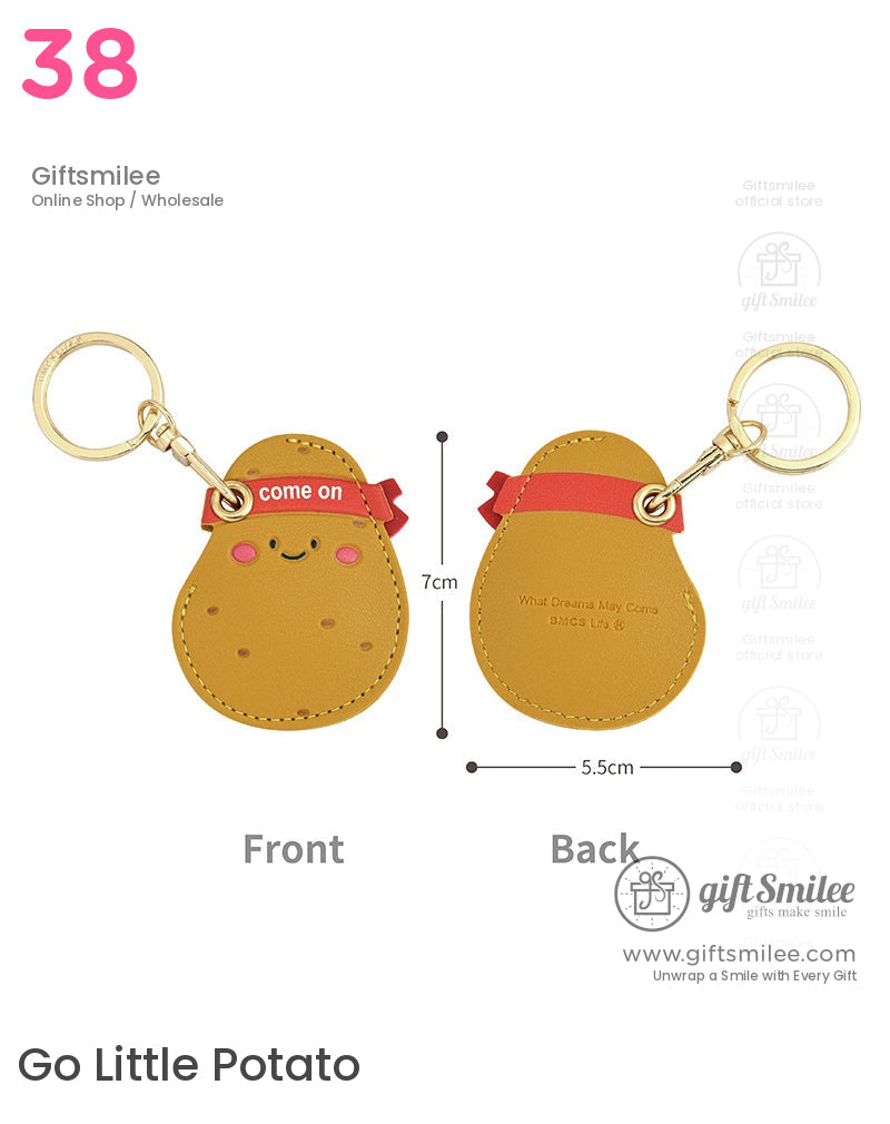 Brown potatoshaped PU leather keychain with goldtone ring smiling face red ribbon detail and playful design