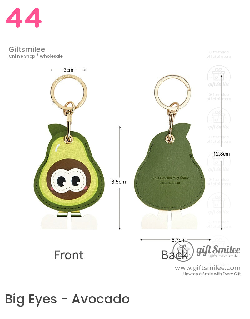 Green pearshaped leather keychain with cartoon face gold metal ring white legs and embossed text on the back