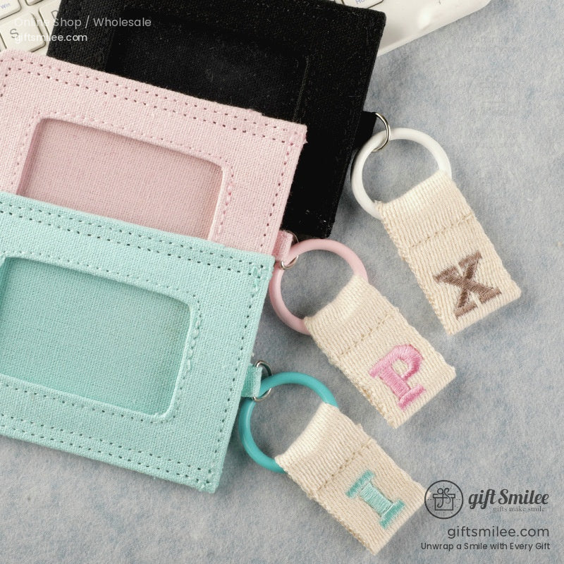 Pastel fabric ID card holders in black pink and mint with keyring accents and embroidered cream straps