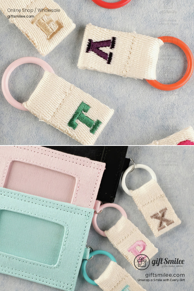 Colorful embroidered letter keychains with pastel and orange rings paired with pink mint and black card holders