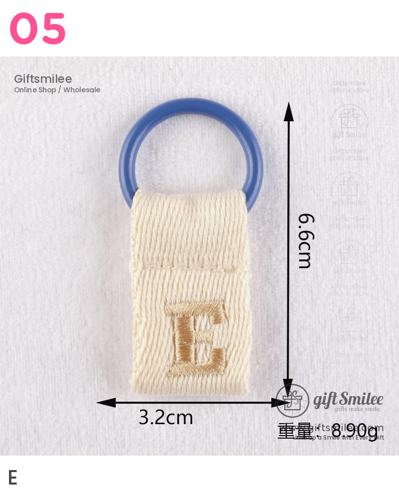 Cream cotton looped strap with blue plastic ring and embroidered gold E measuring 66cm x 32cm weighs 89g