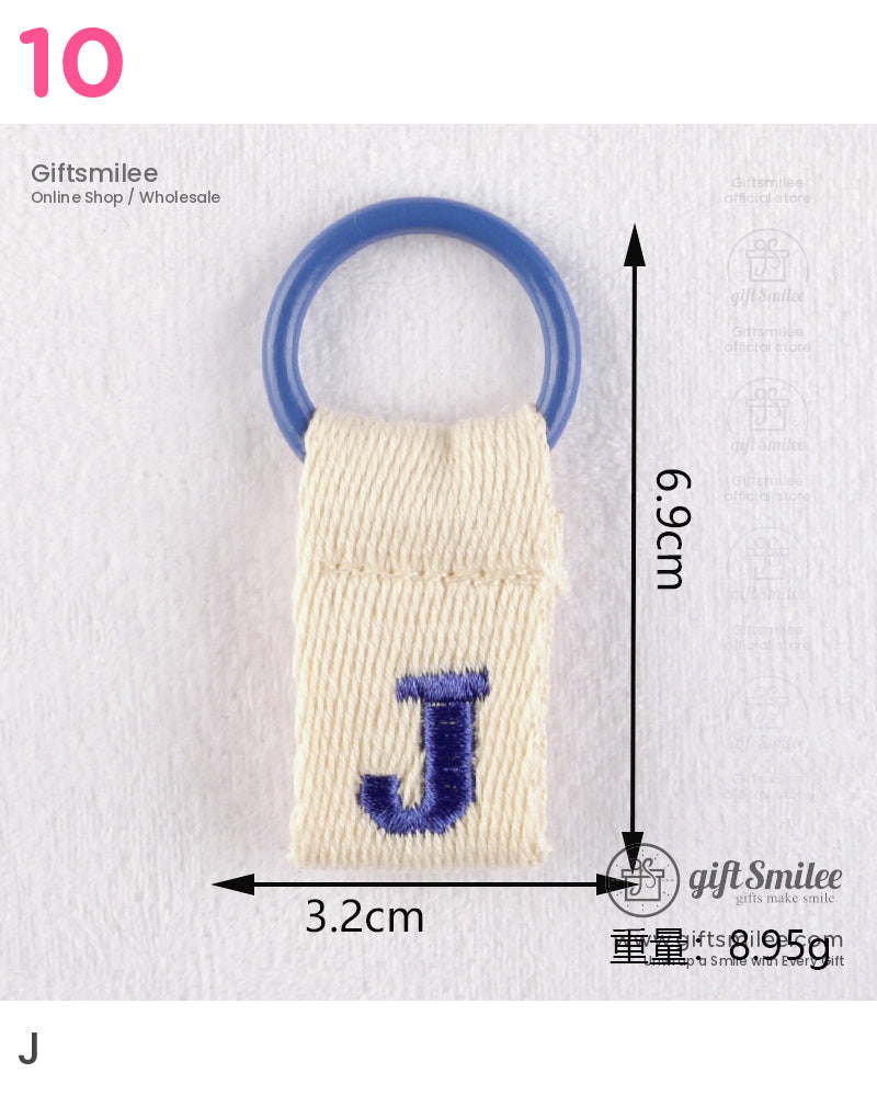 Cream cotton keychain with blue stitched J and attached circular blue plastic ring measuring 69 cm by 32 cm