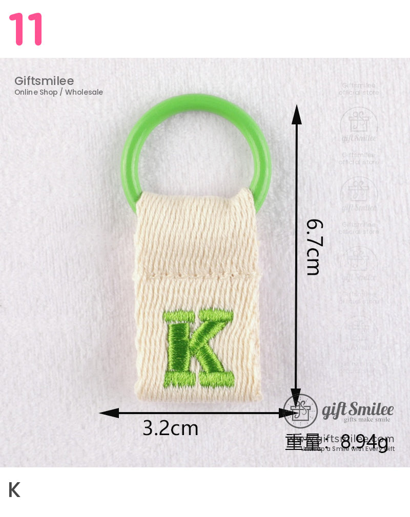 Cream fabric tag with green embroidered K and a bright green plastic ring measuring 67cm by 32cm