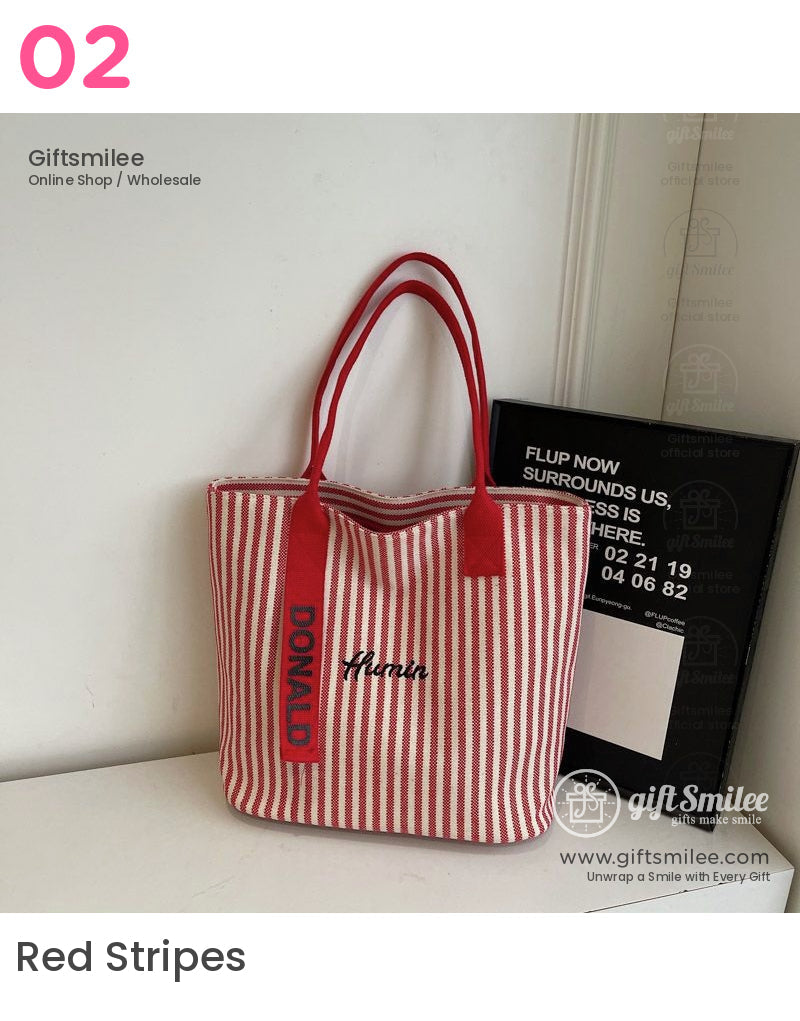 Red and white striped canvas tote bag with bold red handles Donald text on strap and Hanin embroidery on the front