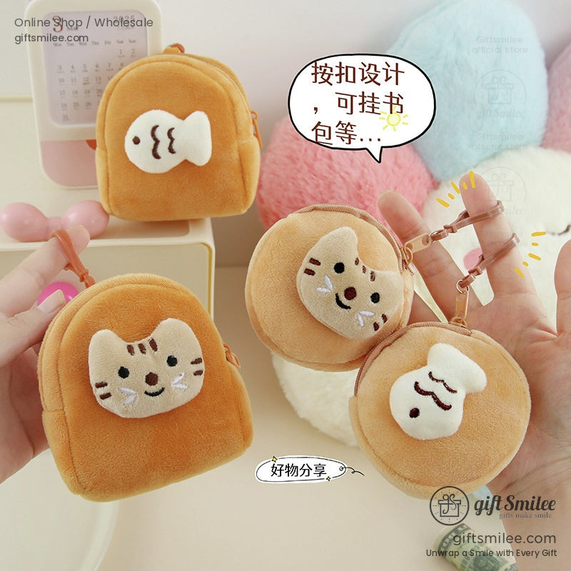 Soft tan plush mini backpack and round coin pouches with embroidered cat and fish designs featuring clasp attachments
