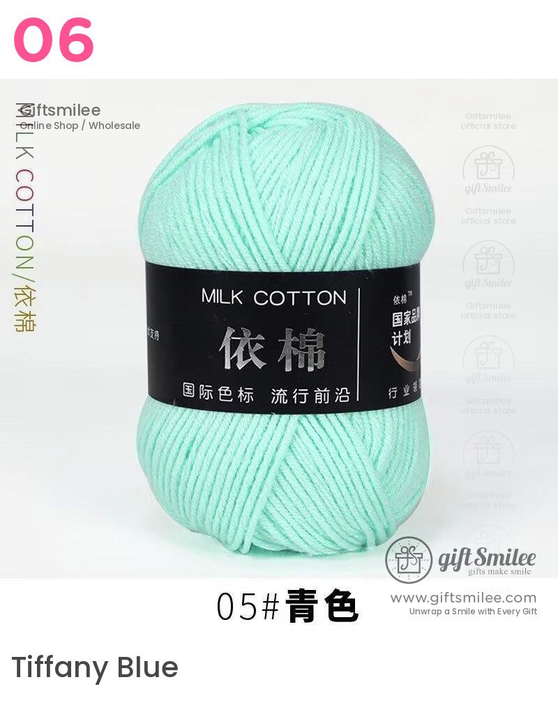 Mint green milk cotton yarn skein with a smooth texture soft finish and black label featuring bold text