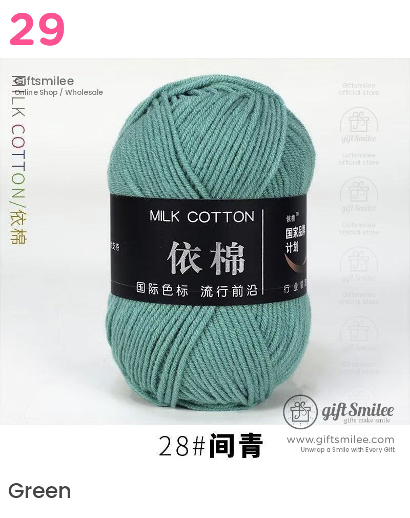 Soft sage green milk cotton yarn ball with smooth texture and black label featuring white and gold text