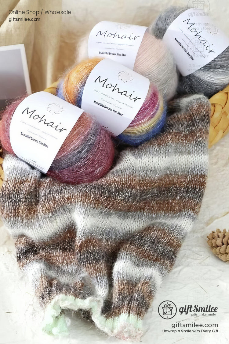 Multicolored mohair yarn balls with labels paired with a handknit striped scarf in soft brown gray and white tones