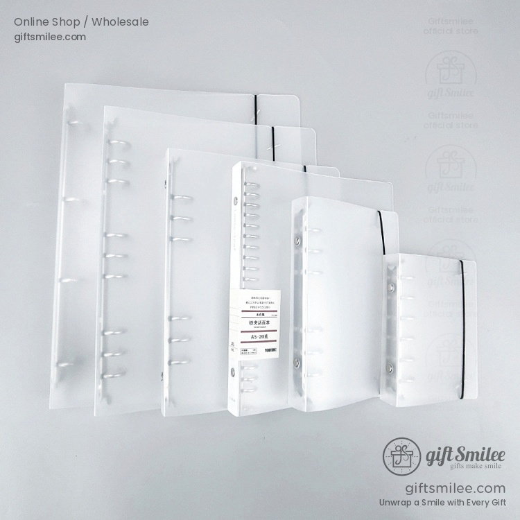 Clear frosted plastic binders in assorted sizes with black elastic closures and sturdy discbound spines