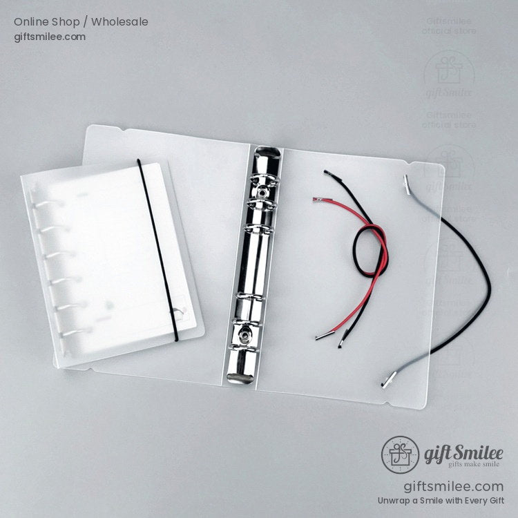 Transparent plastic binder cover with a silver metal ring mechanism elastic band and red and black wiring