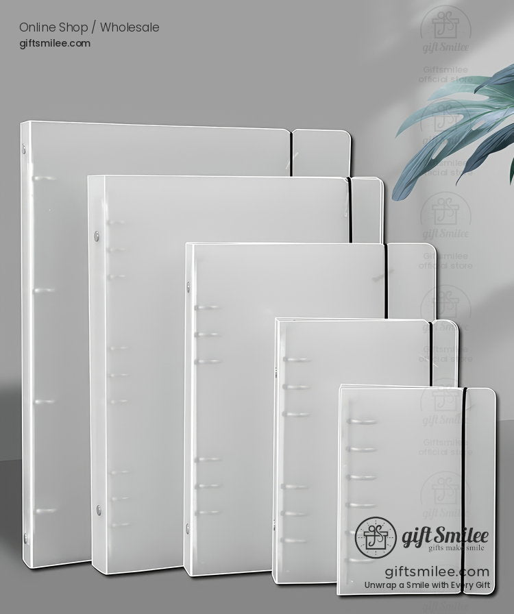 Set of slim white translucent plastic binders in assorted sizes with snap closures displayed on a gray surface