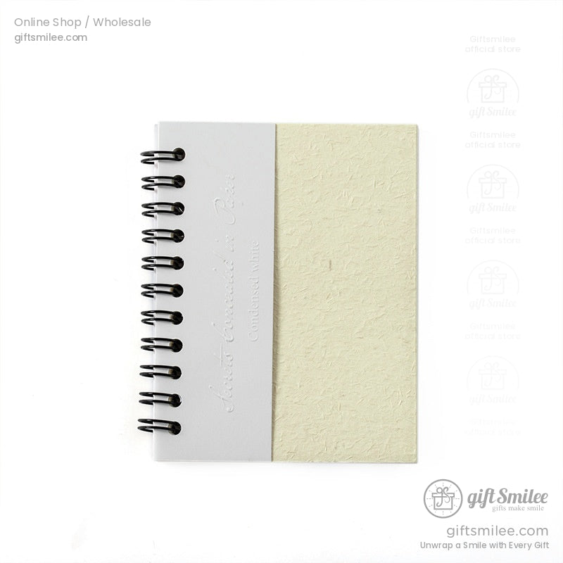 A5 spiral-bound notebook with textured beige cover and white spine, minimal design for journaling or office notes