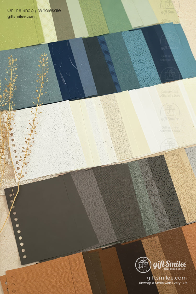 Color and texture swatch cards for gift packaging materials laid out in rows on a neutral background, showcasing greens, blues, neutrals, and earth tones.
