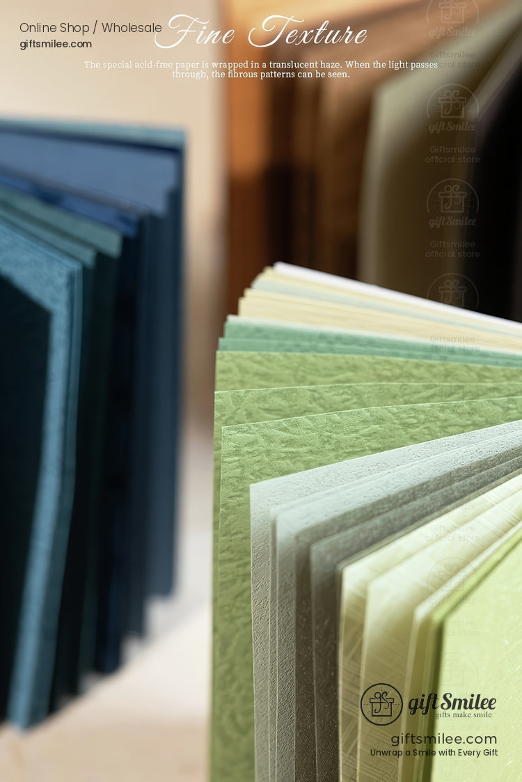 Textured pastel and navy cardstock sheets displayed in a fan, premium fine-texture craft paper for invitations and DIY from giftSmilee wholesale.
