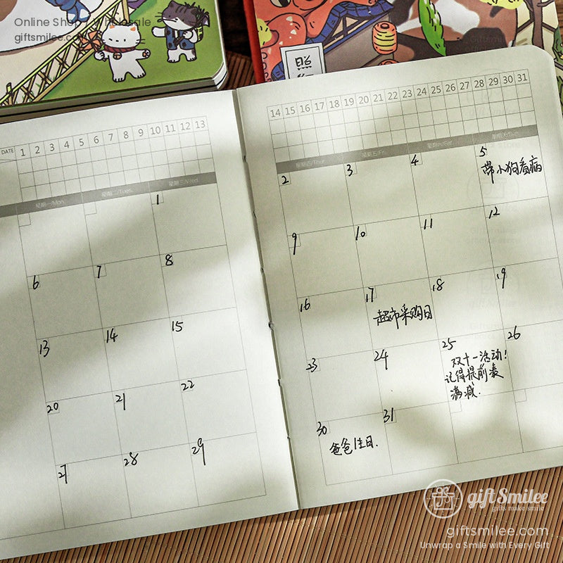 Open beige planner with a monthly calendar layout handwritten notes in black ink placed on a wooden surface