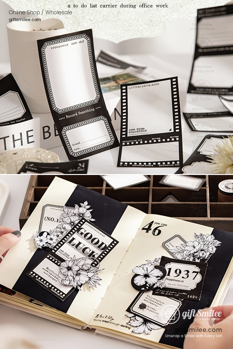 Black-and-white vintage film frame sticky notes and retro label stickers used for journaling and scrapbooking on a desk.