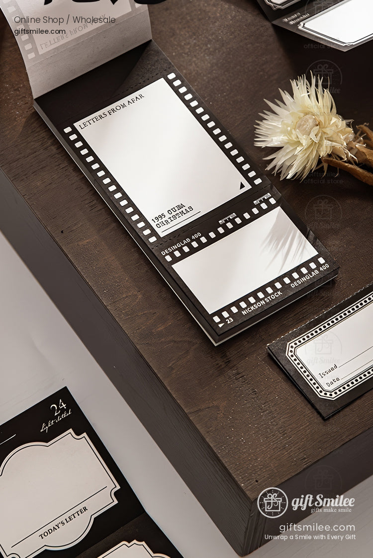 Vintage filmstrip-themed memo notepad set on wooden desk – black and white “Letters From Afar” stationery by giftSmilee.