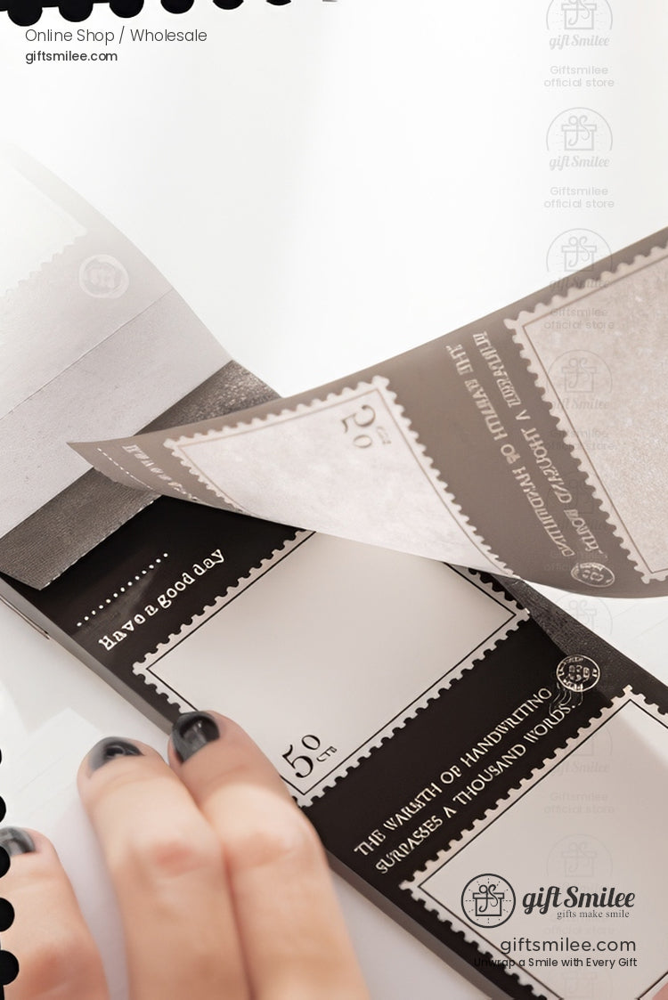 Vintage postage stamp–style memo pad with tear-off notes, black and white design, held in hand – giftSmilee stationery for journaling and scrapbooking