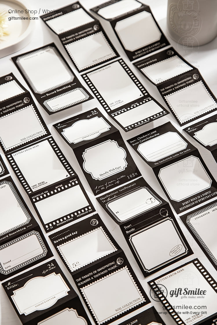 Vintage-style black and white label stickers for planners and scrapbooking laid out on a desk