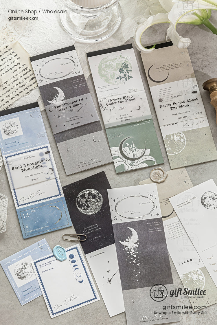 Aesthetic moon-themed stationery set laid out on a desk, featuring bookmarks and memo pads with celestial designs in neutral tones.