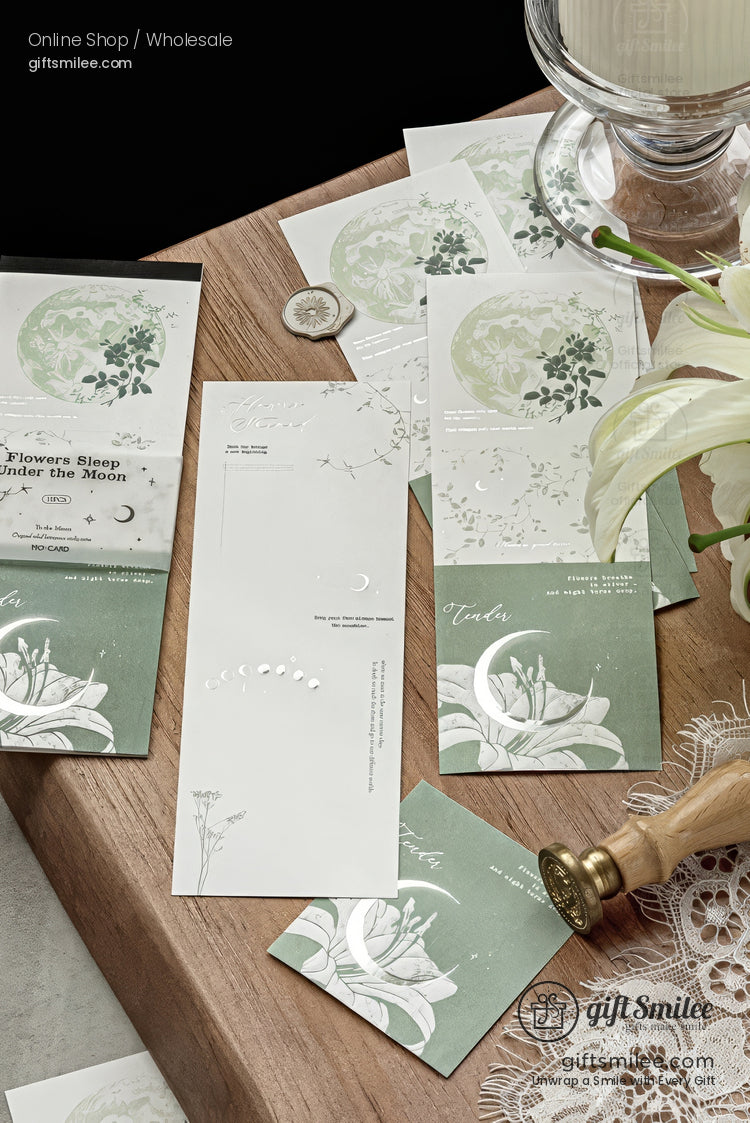 Green floral moon-themed bookmark and stationery set on wooden desk with lily and wax seal, by gifsmilee (gift stationery).