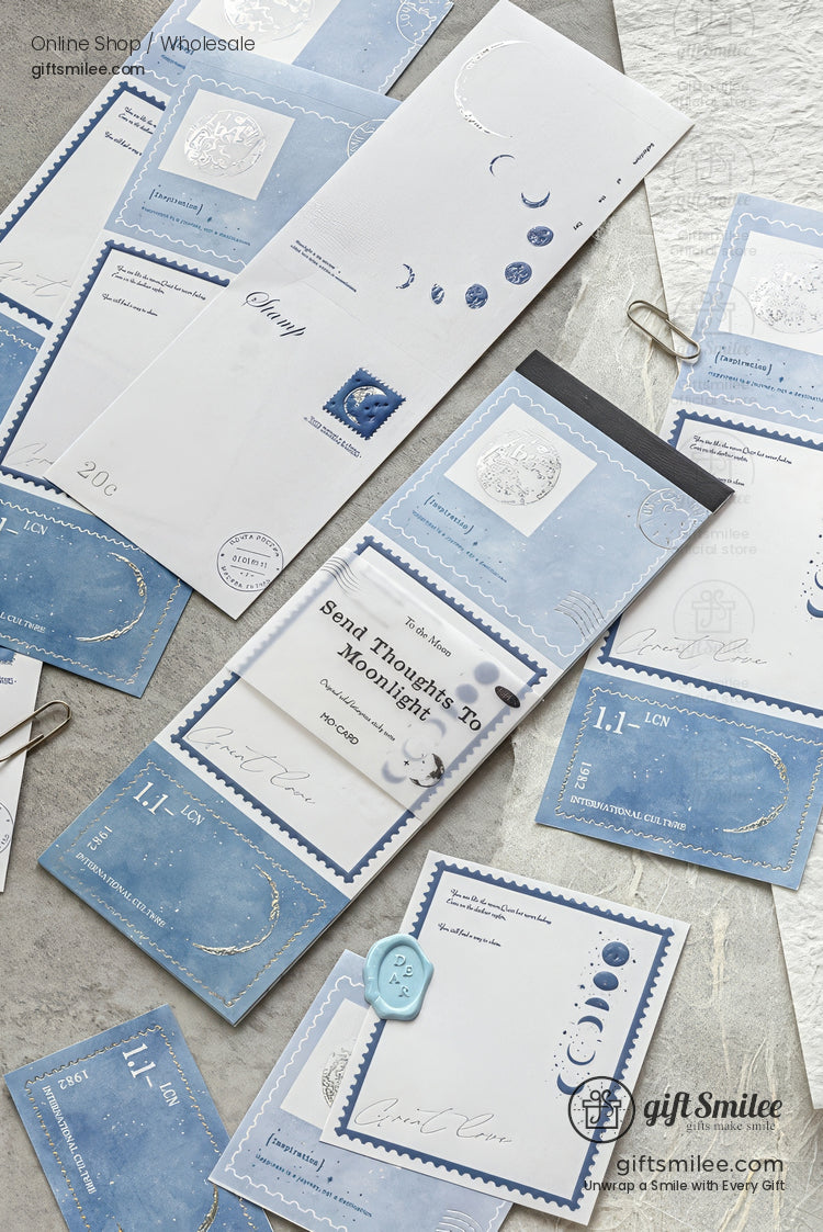 Moon-themed blue stationery set with envelopes, postcards, and notepads arranged flat lay for giftSmilee stationery collection
