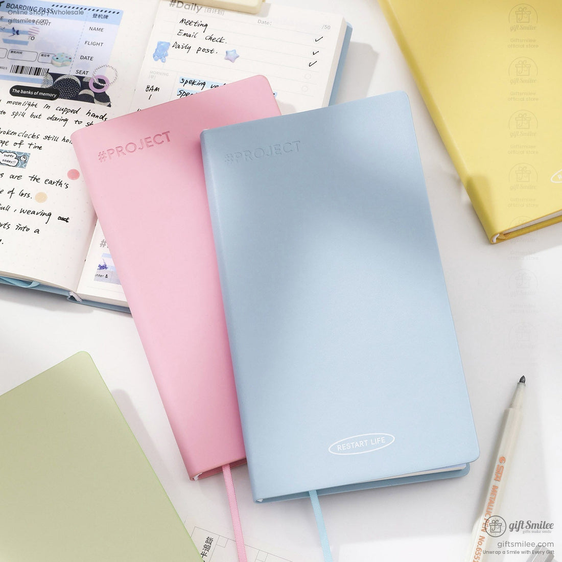 50-day planner notebook set on desk with open habit tracker and light blue cover, ideal for productivity and scheduling in Shopify stationery collection