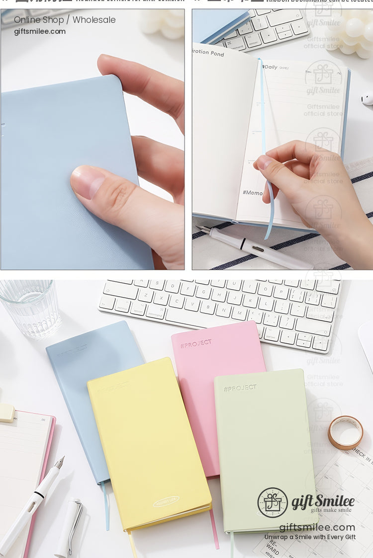 Pastel hardcover pocket planners with ribbon bookmarks on a minimalist desk setup (blue, yellow, pink, and mint).