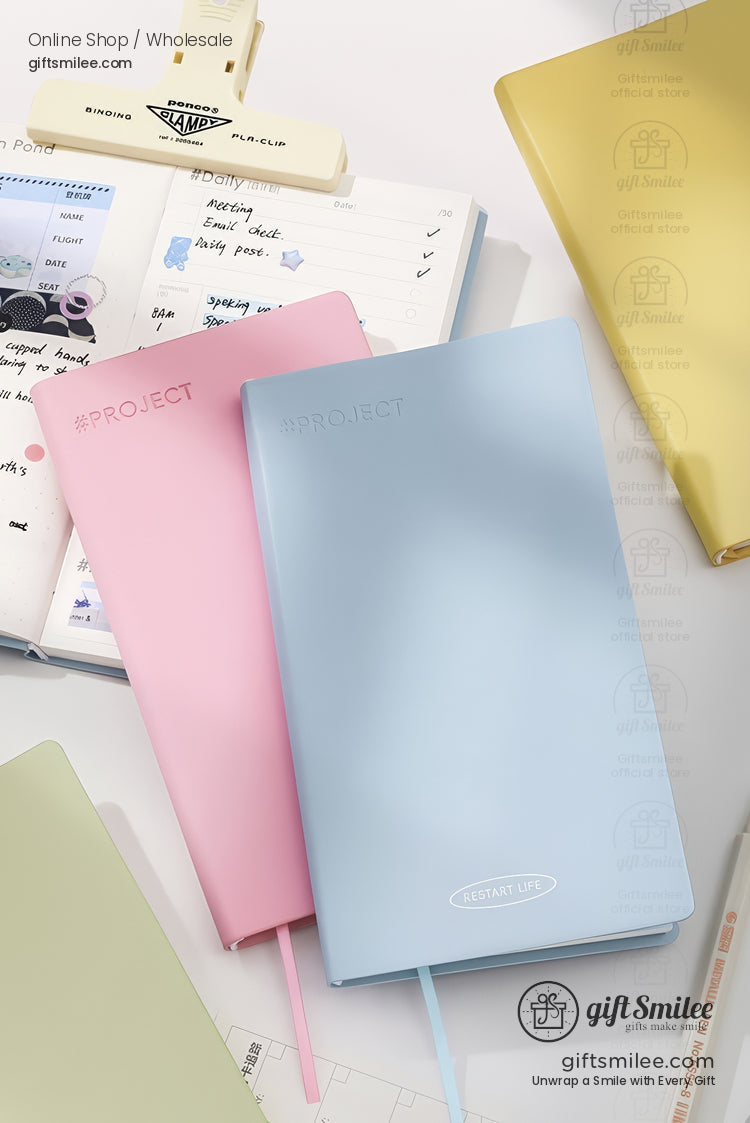 Pastel hardcover project notebooks (blue and pink) on a desk with planner and stationery — Giftsmilee productivity journals for students and office.