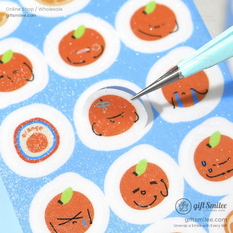 Glittery kawaii strawberry stickers on a purple washi tape roll with adorable expressions