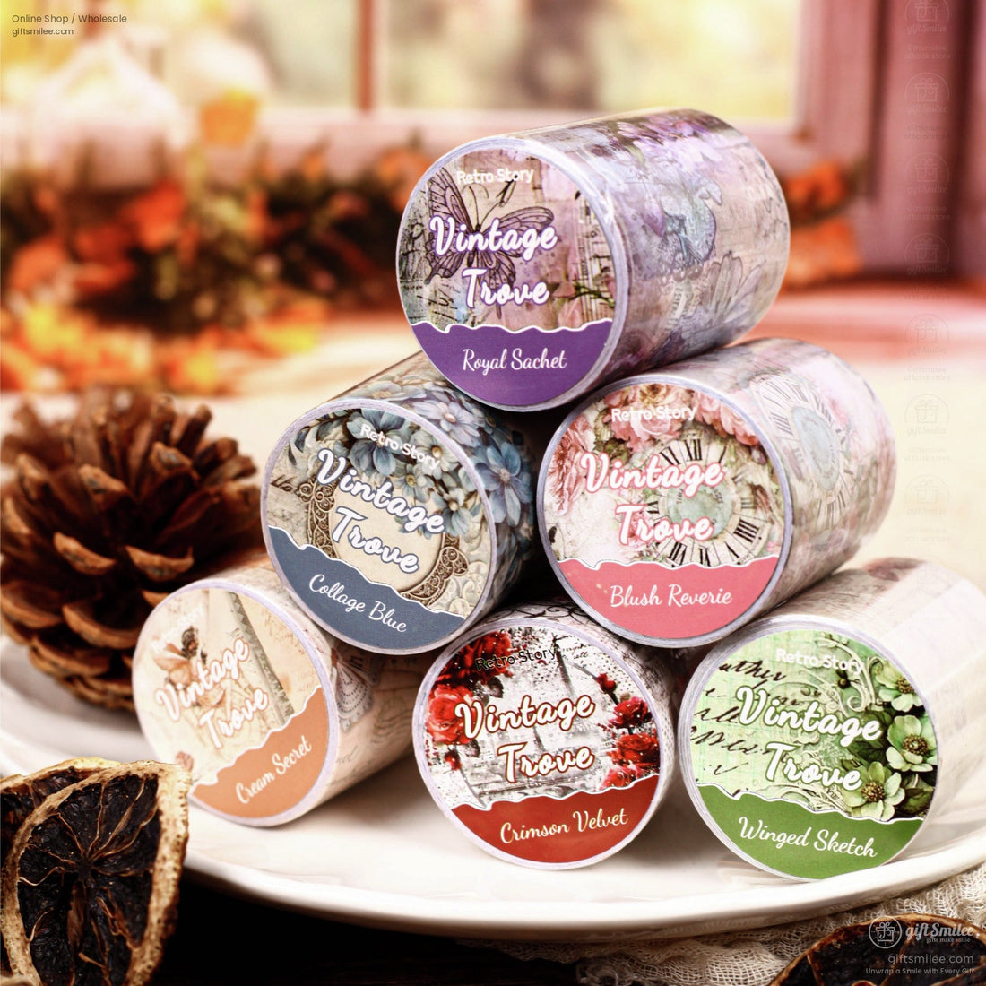 Close-up of vintage floral and butterfly-themed washi tape rolls arranged on a wooden surface
