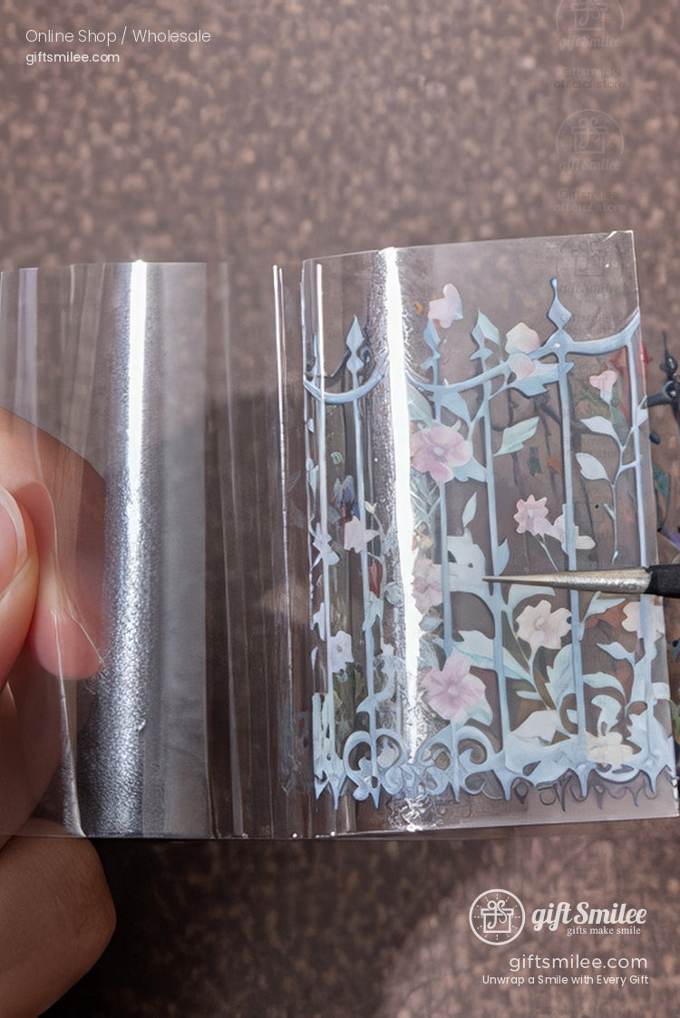Clear floral transfer sticker sheet with pastel gate and vine design being peeled back by hand, giftsmilee craft supply.