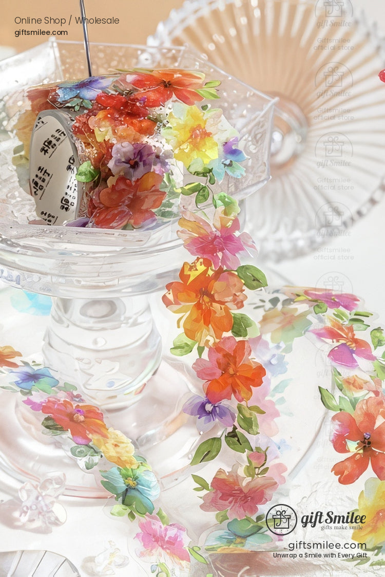 Transparent floral washi tape with colorful flower stickers displayed on a clear glass stand – giftsmilee decorative craft tape for scrapbooking and journaling.