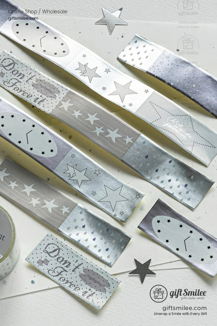 Silver and white star-patterned gift wrapping paper strips and labels from giftsmilee, flat lay product photo