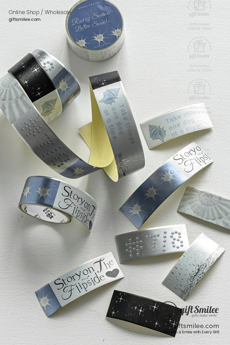 Silver and blue decorative washi tapes with star, moon, and “Story on the Flipside” designs arranged flat-lay on a light background.