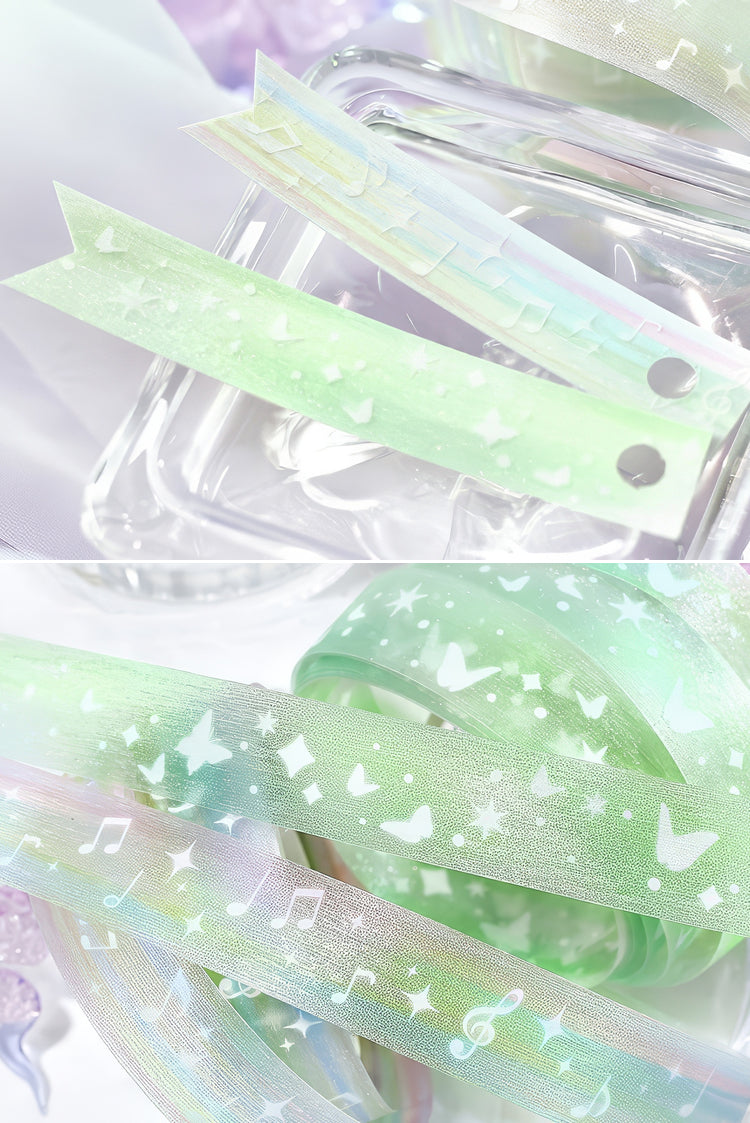 Iridescent green washi tape with white butterfly music note and star patterns perfect for crafts and decor