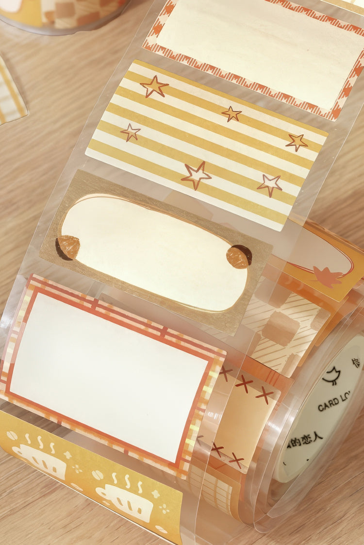 Transparent adhesive tape with orange and yellow decorative patterns including stars stripes and coffee cup designs