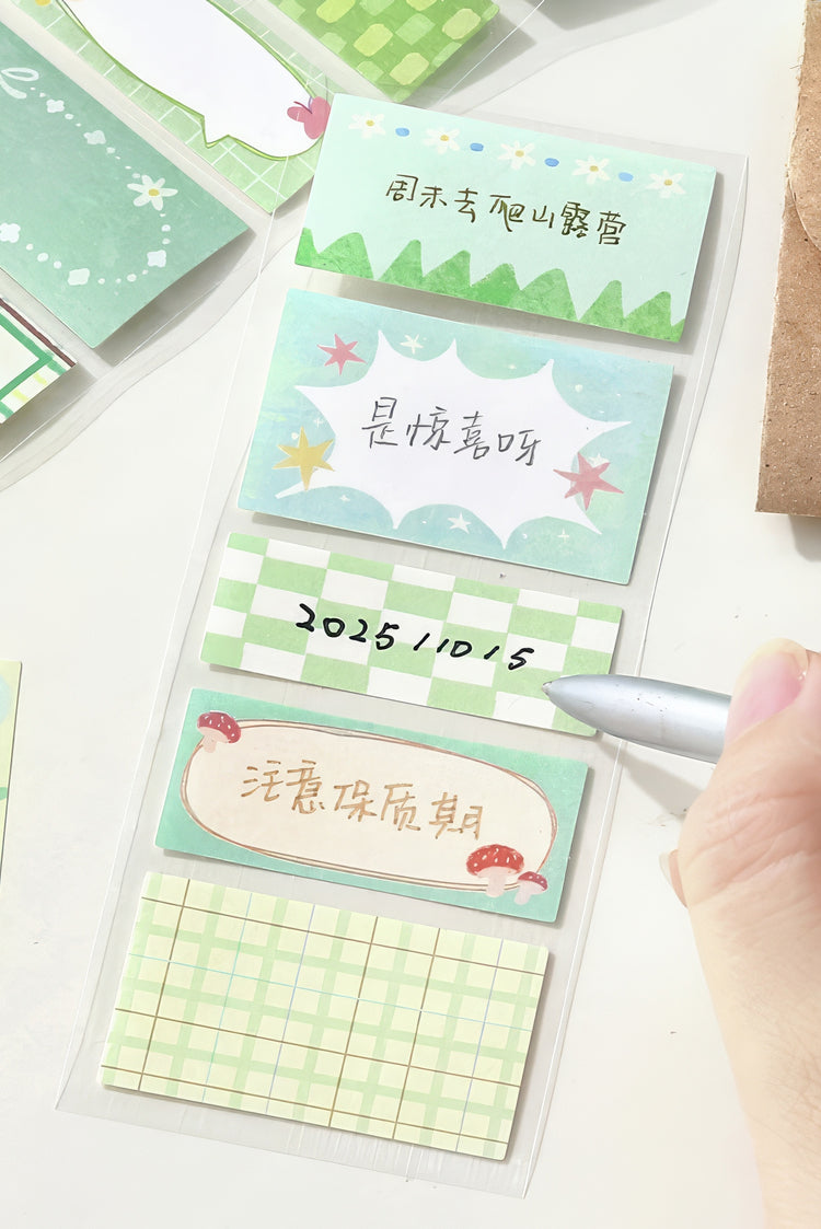 Pastel green sticky notes with checkered grid and decorative patterns featuring handwritten designs and accents