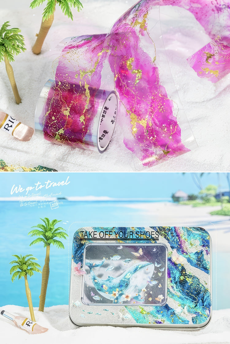 Purple and gold marblepatterned adhesive tape and tropicalthemed tin box with glittery blue ocean design