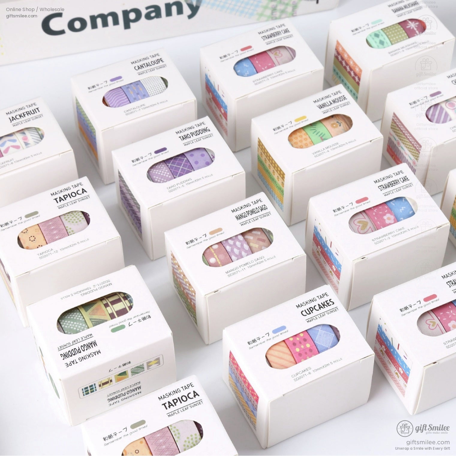 Assorted decorative masking tape sets in white boxes with colorful patterns including stripes dots and themed designs