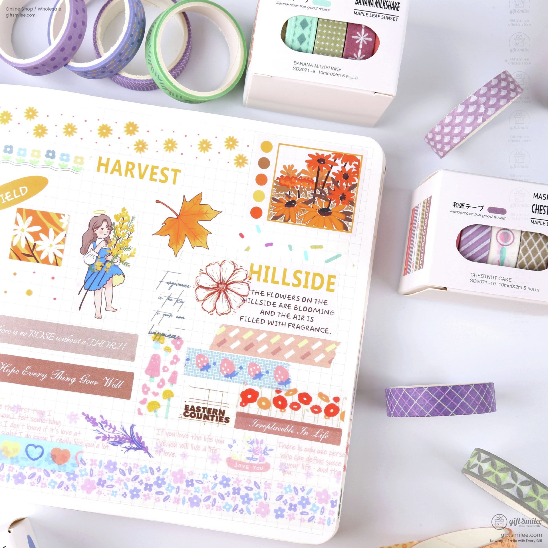 Pastelcolored decorative washi tapes with floral plaid and abstract patterns alongside a scrapbook featuring autumnal designs