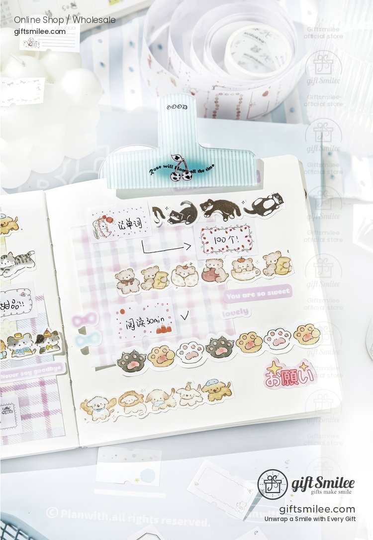 Pastelthemed open planner adorned with animalshaped stickers paw print designs and colorful decorative tape strips
