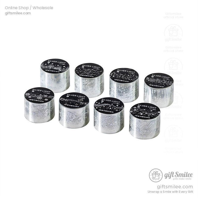 Set of eight silver holographic decorative tapes with black lids featuring assorted intricate patterns and shiny finish