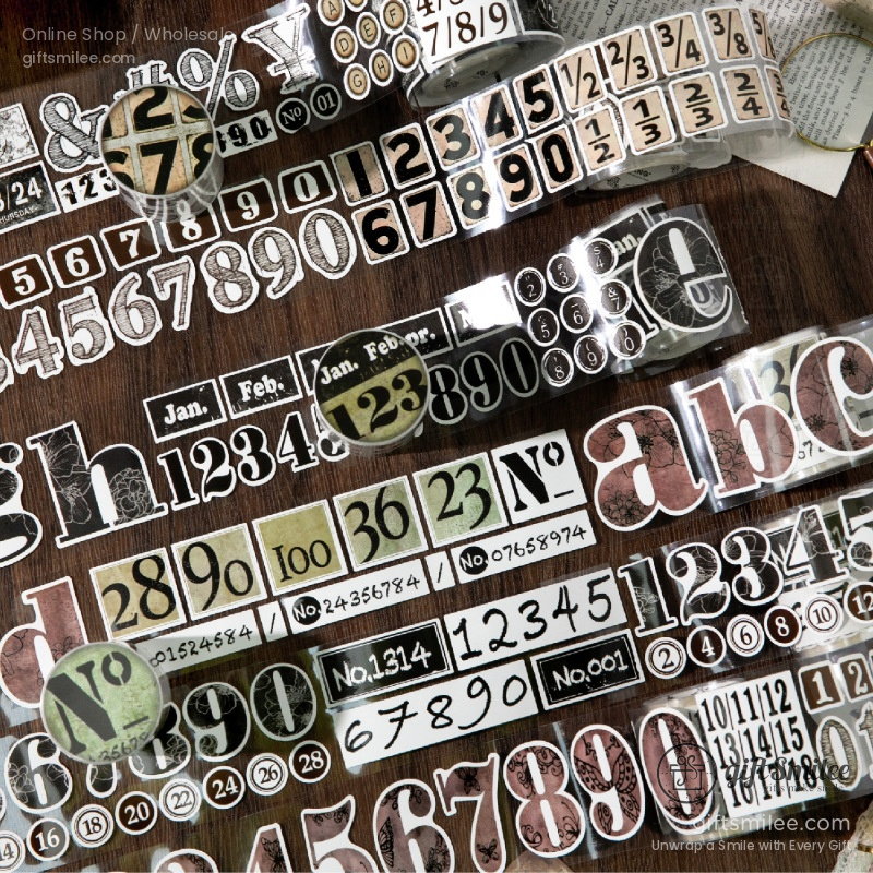 Vintagestyle decorative washi tape rolls with numbers alphabets dates and symbols in muted tones on a wooden surface