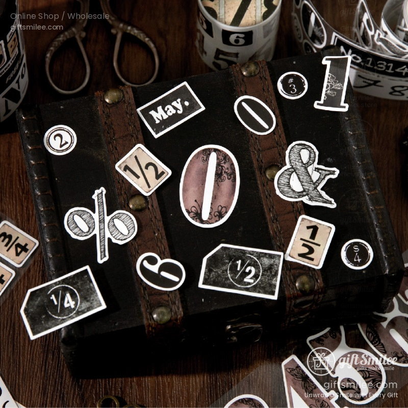 Vintagestyle black leather box adorned with eclectic numeral and symbol stickers accented with aged brass studs