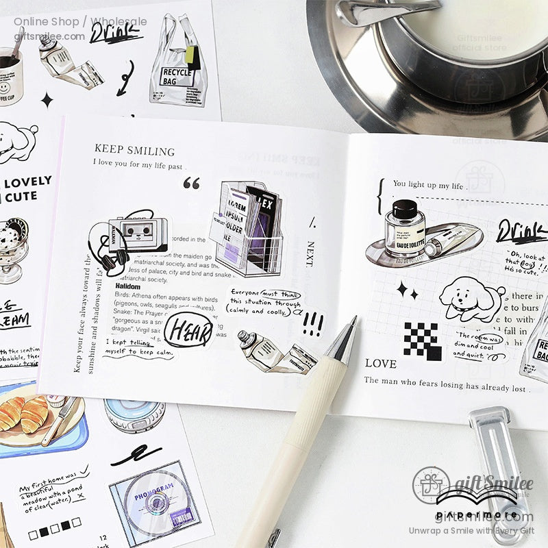Aesthetic stationery flat lay with open journal, pen, and cute black-and-white sticker set for scrapbooking and planners