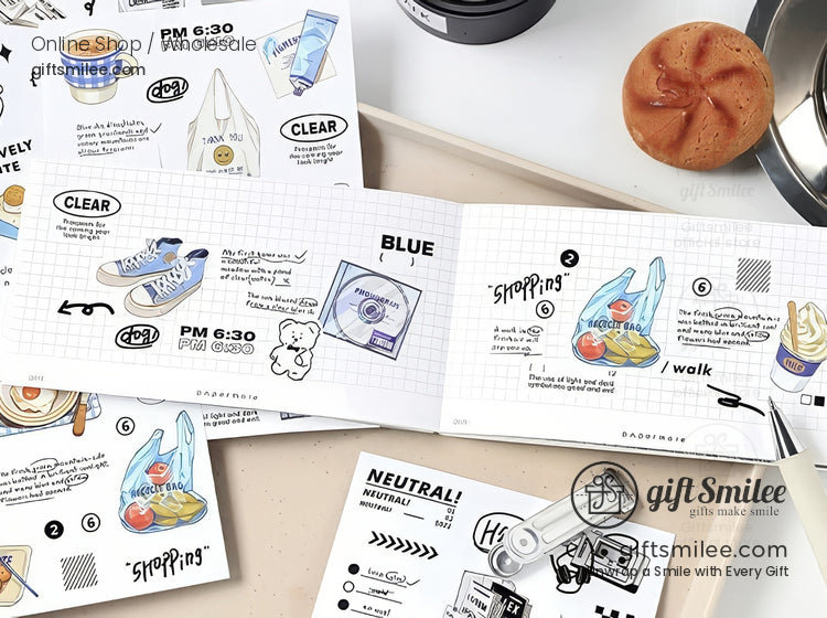 Cute shopping-themed sticker sheet and notebook flat lay with hand-drawn grocery bag, sneakers, and doodles on a grid background, styled on a desk with pastry and coffee props.