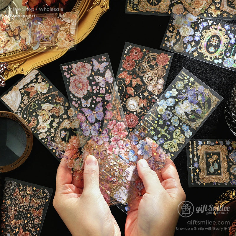 Holographic floral and butterfly sticker sheets in vintage style being held in hands, decorative scrapbooking stickers for planners and crafts.