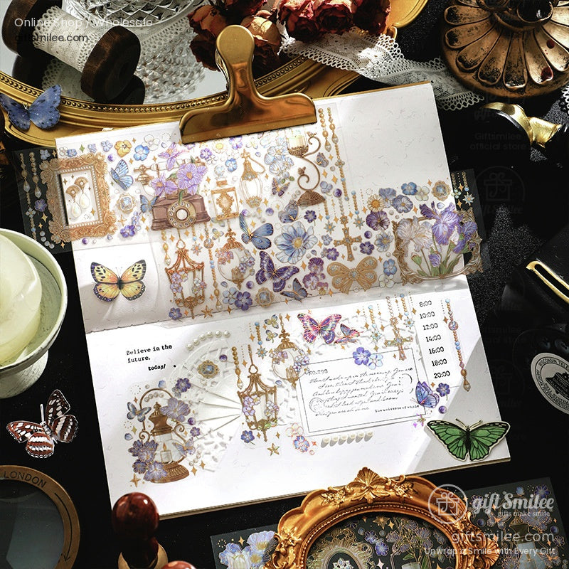 Vintage scrapbook journal spread with gold accents, floral stickers, and butterfly decals on a desk flat lay.