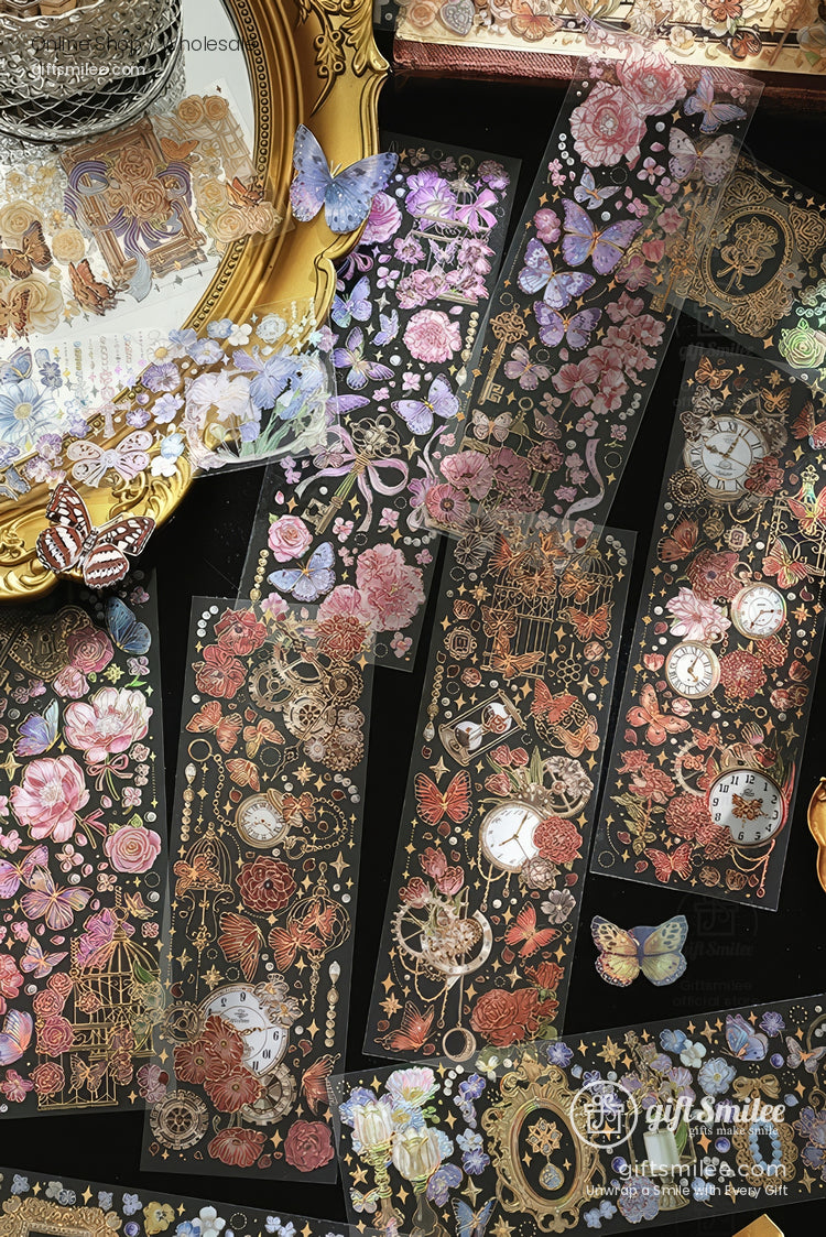Vintage floral and butterfly scrapbook stickers on black background with gold accents and clocks, styled flat lay for craft supplies.